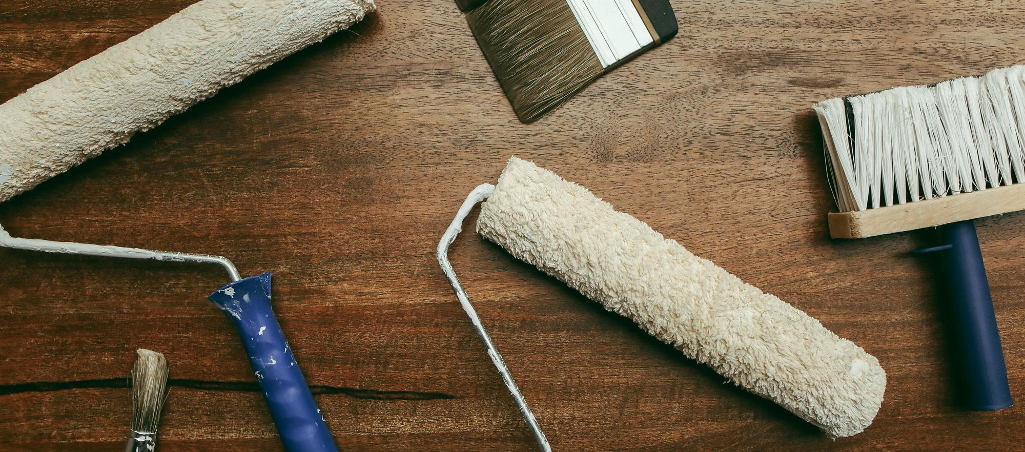 Painting supplies laid out on a wooden surface