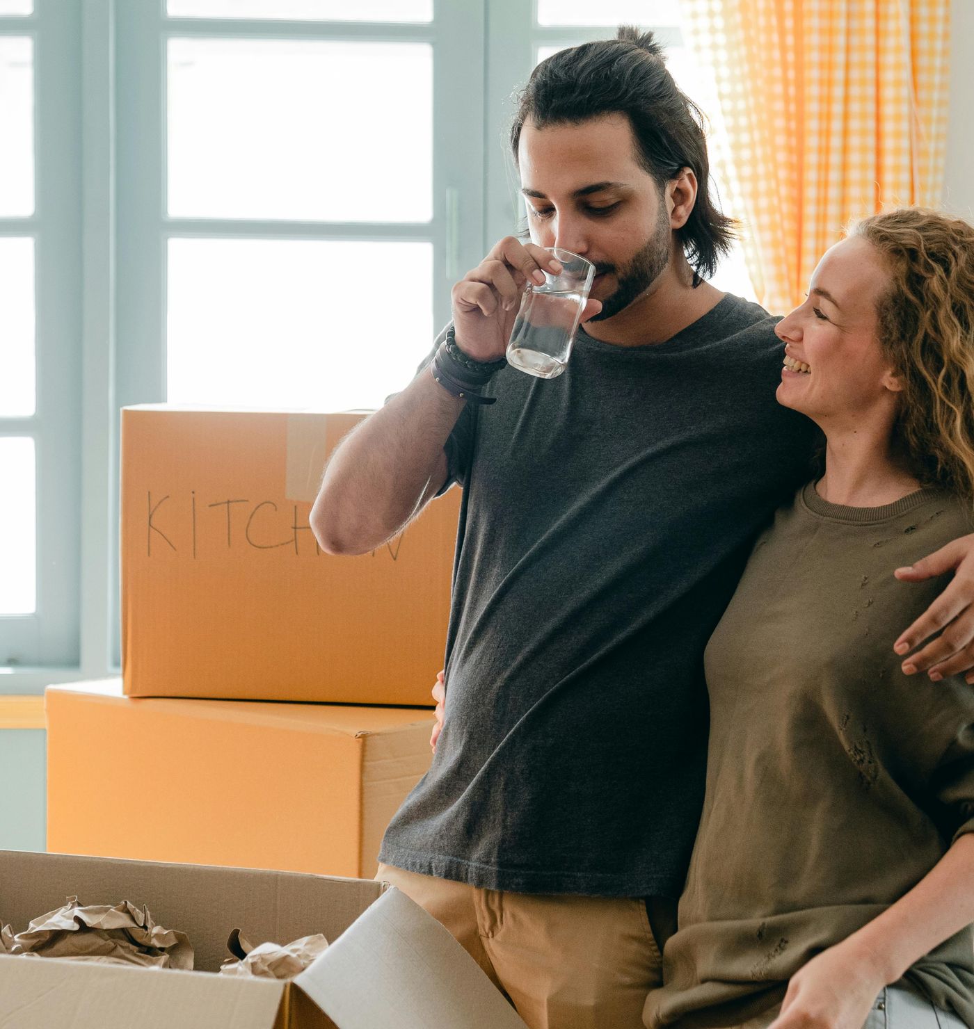 A happy couple moving into their new house