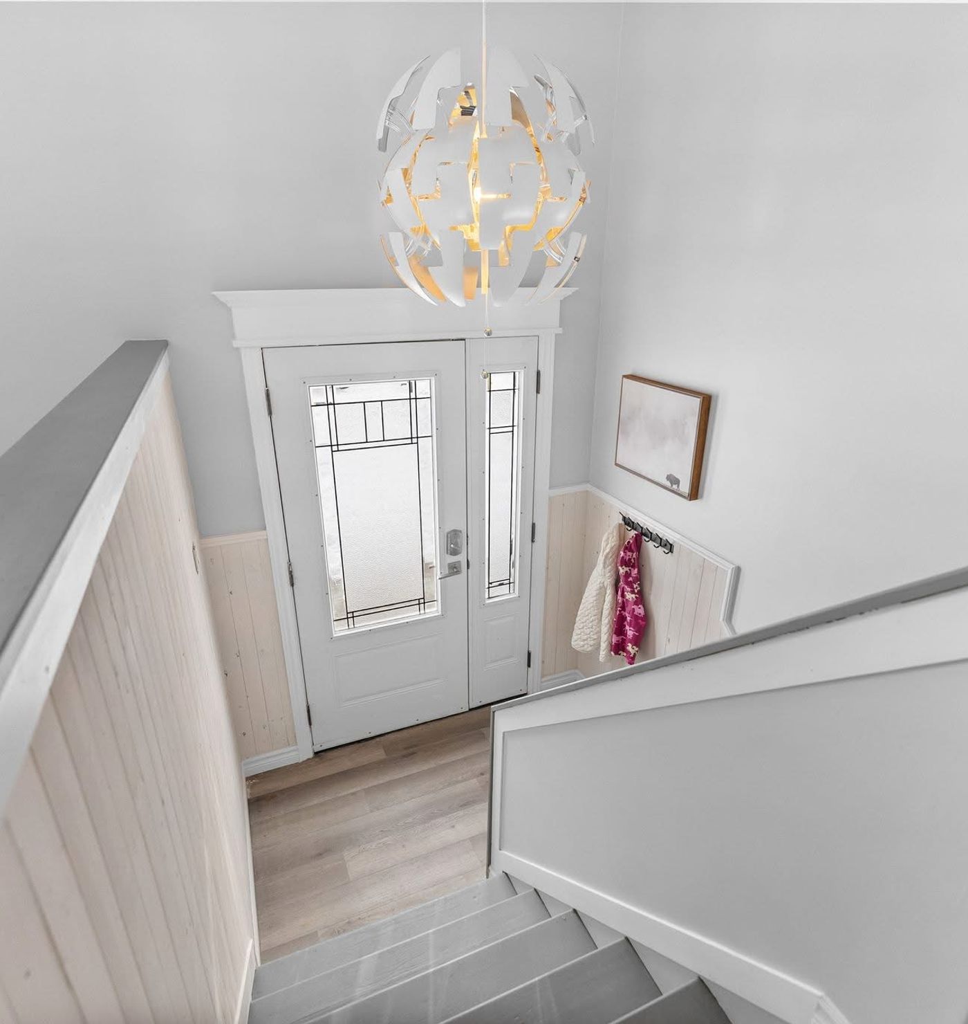 Front staircase with newly painted walls and new flooring